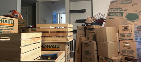 A Queen of To Do assistant unpacks moving boxes in a client's new Austin home.