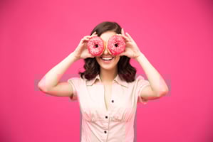 woman with donuts on two hands