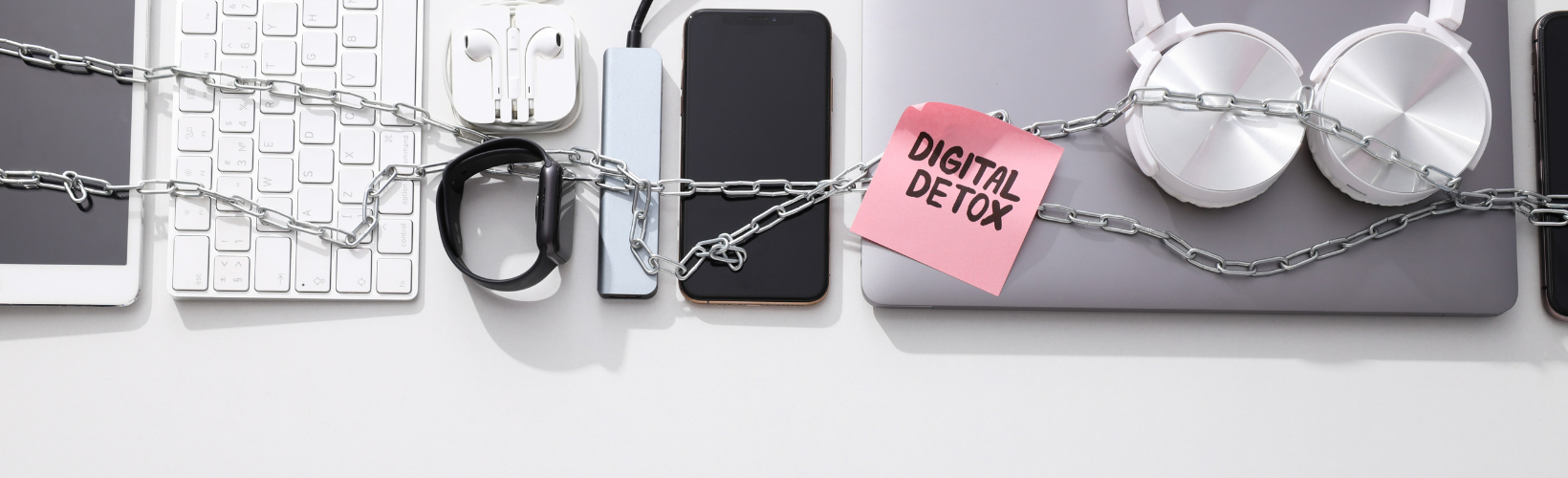 Chained electronic devices including a tablet, smartphone, headphones, and smartwatch with a pink sticky note reading 'Digital Detox'