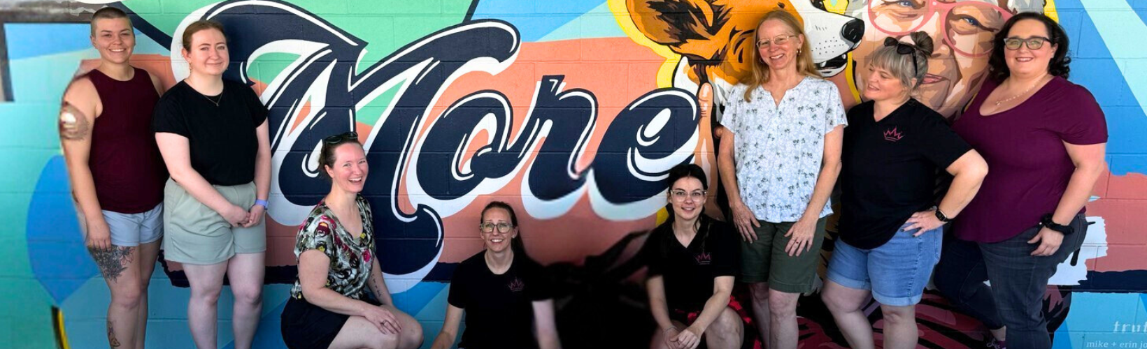 Queen of To Do, Personal Assistant and Lifestyle Concierge, smiling in a team picture after an event in Austin, TX.